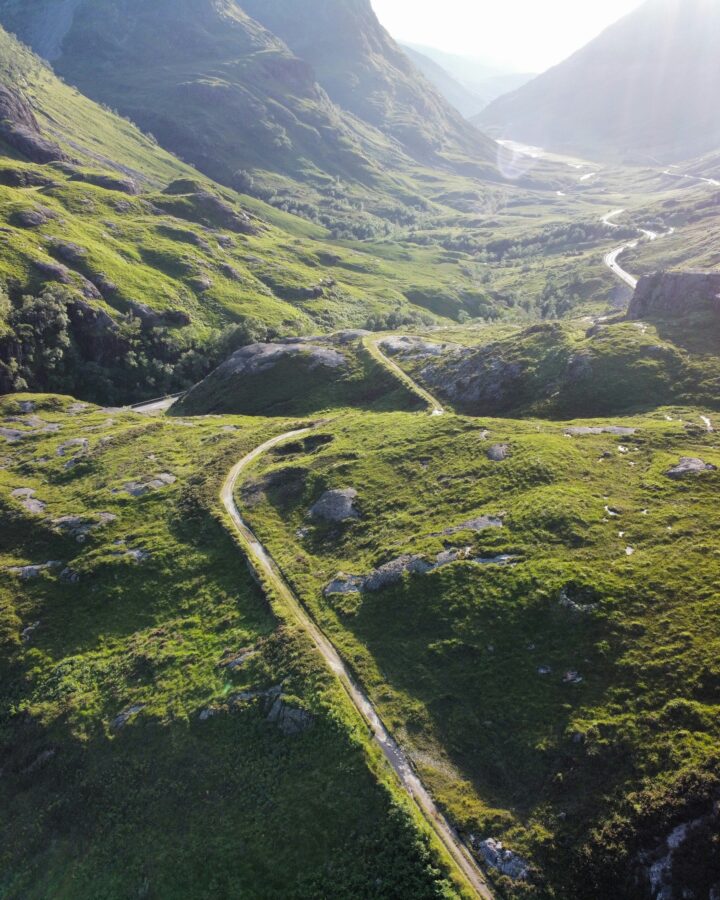 A winding mountain path through a peaceful landscape, symbolizing the journey of healing through faith and therapy.